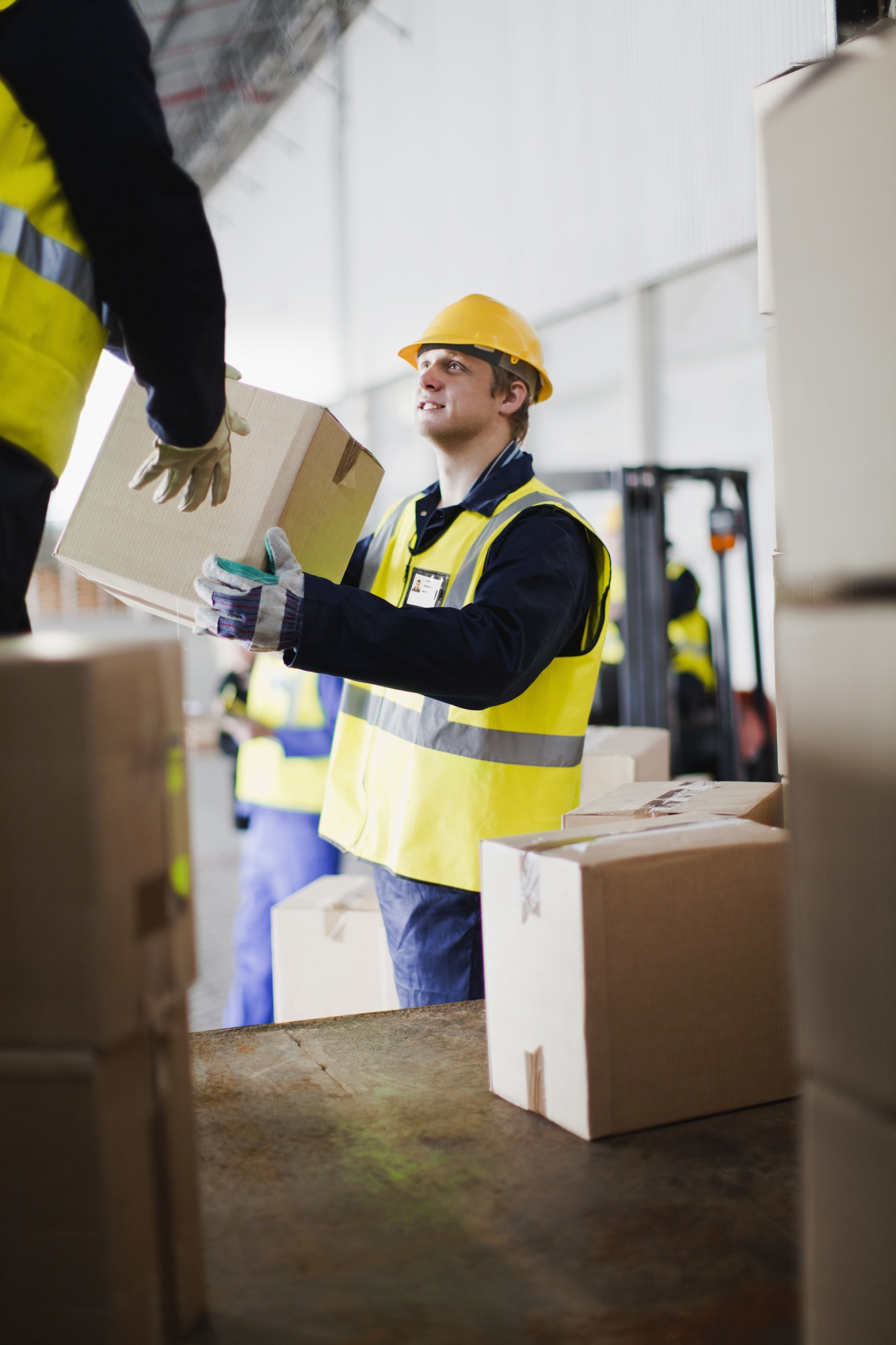 Workers unloading boxes from truck